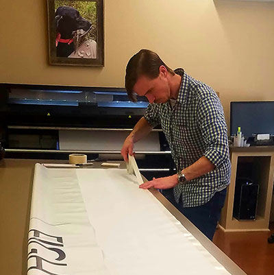 photo of George working on banner