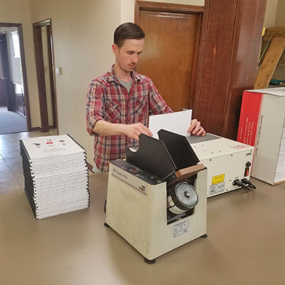 photo of George working on binding machine