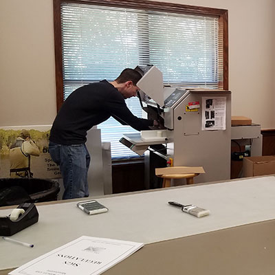 photo of George working on the cutting machine